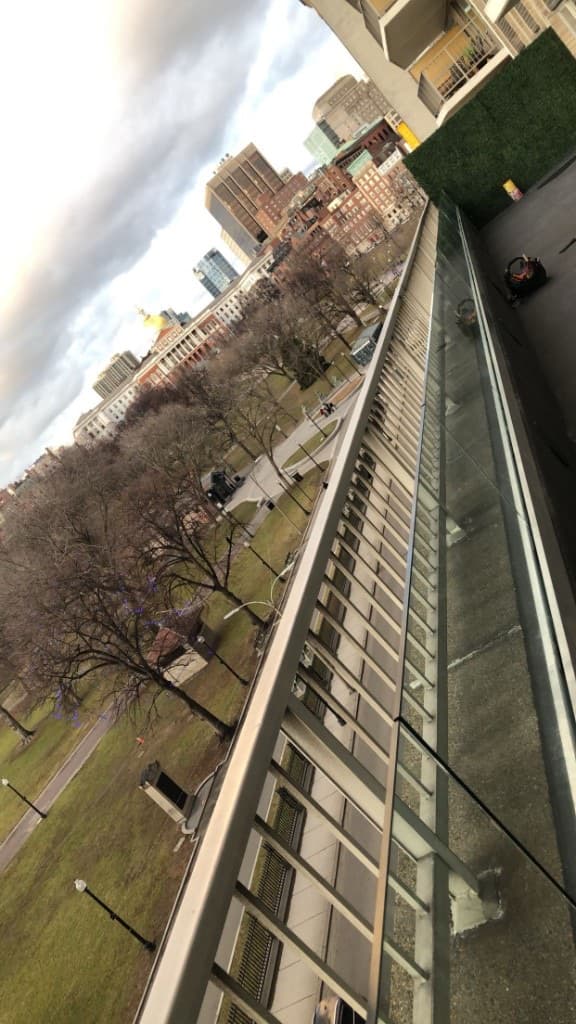 Exterior glass balcony railing overlooking Boston and the Common
