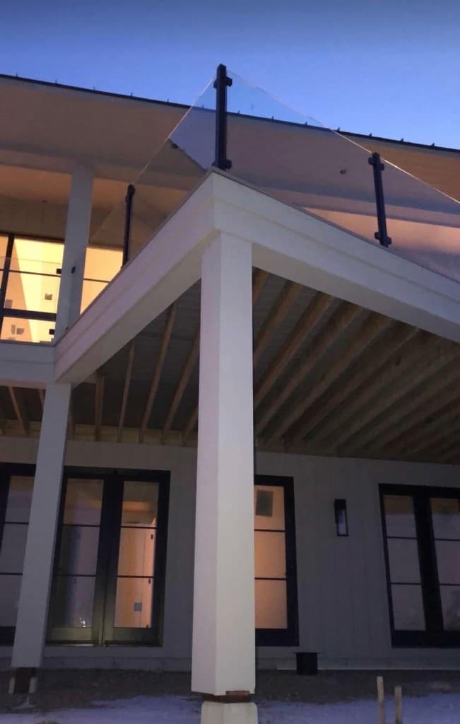Residential glass railing on a modern balcony at dusk